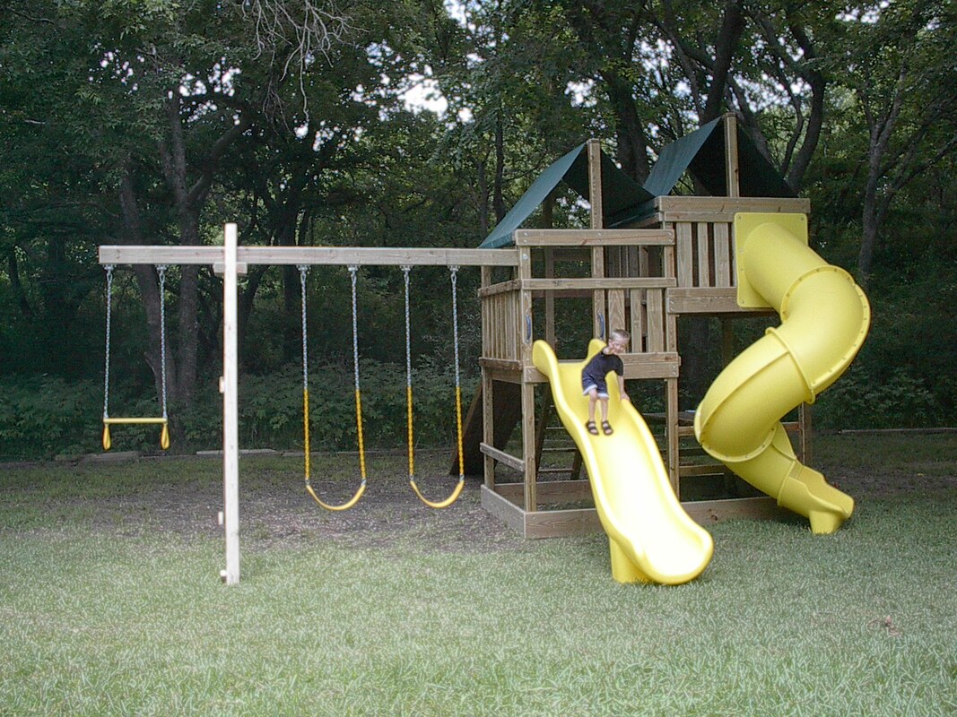 Gemini Playset with two slides, wood roofs, monkey bars and four swing positions.